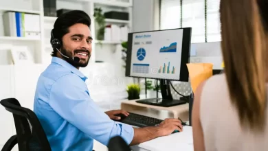 Firozabad-smiling-indian-man-working-as-customer-support-operator-headset-call-center-portrait-sales-agent-sitting-desk